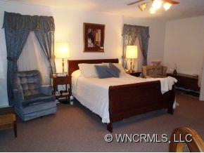 295 Roper Loop Road Rutherfordton, NC 28139 - Photo 10 of 12 a bedroom with a bed and window