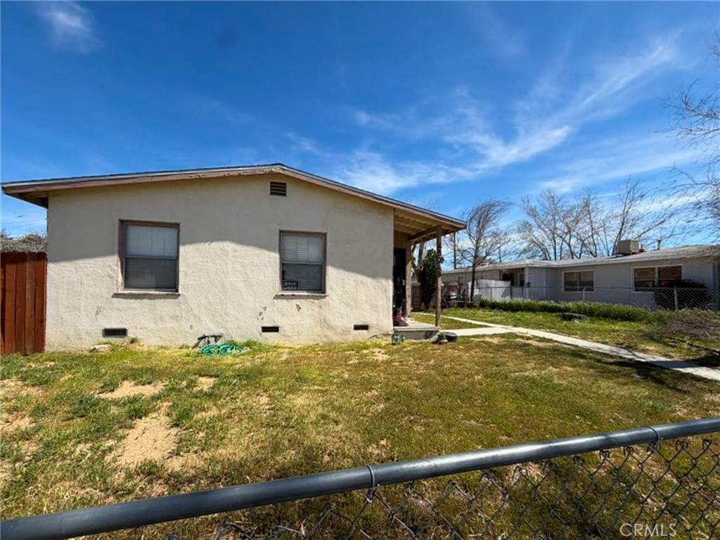 45348 10th Street West Lancaster, CA 93534 - Photo 2 of 2 a front view of a house with a yard