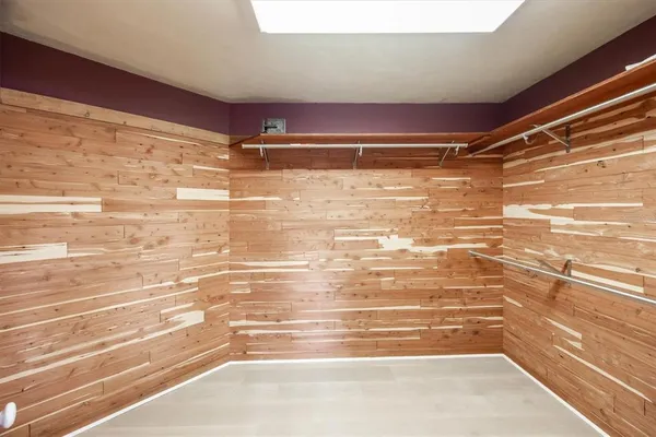 a spacious bedroom with a bed and a mirror