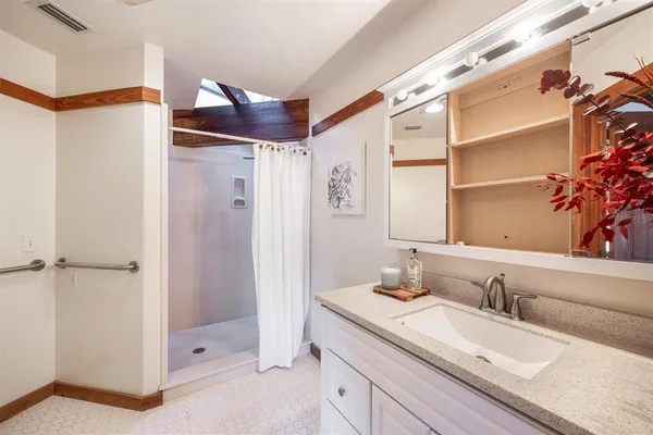 a large bedroom with a large bed and a large window