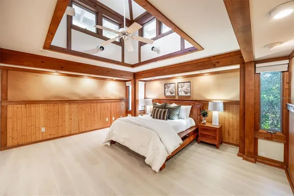 a spacious bedroom with a bed and a large window