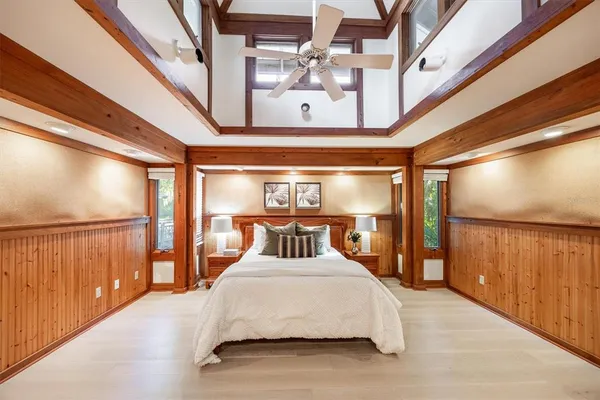 a view of a big room with wooden floor and windows