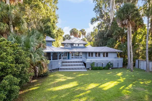 an aerial view of a house with swimming pool patio and lake view