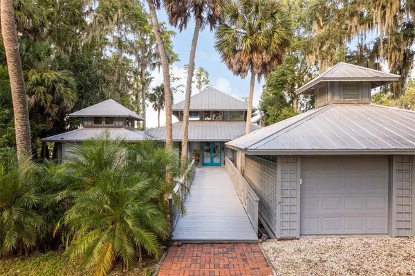 a view of a house with a yard and tree