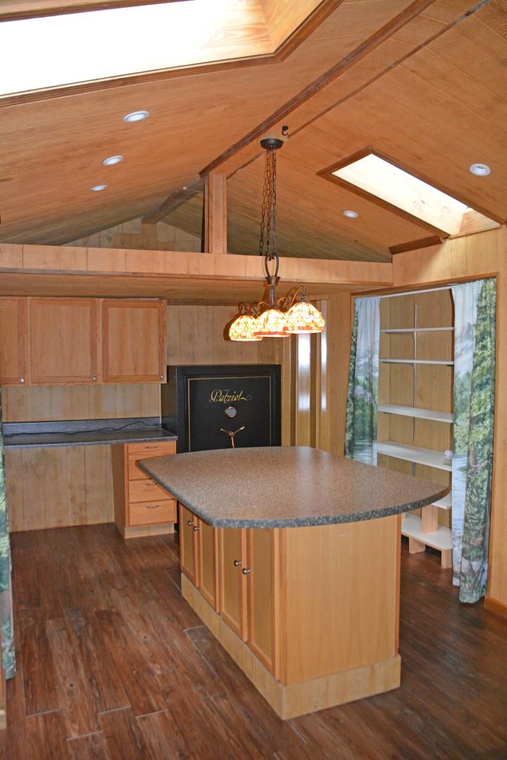 1086 Westfield Road Dickson, TN 37055 - Photo 6 of 30 Large room off of the kitchen used for a pantry and utility room. Lots of storage, skylights, and an island. Patriot safe remains.