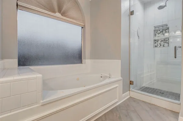 a bathroom with a bathtub and shower