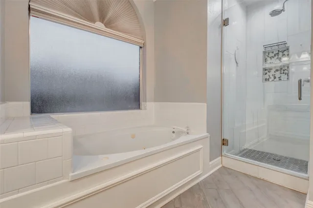 a bathroom with a bathtub and shower