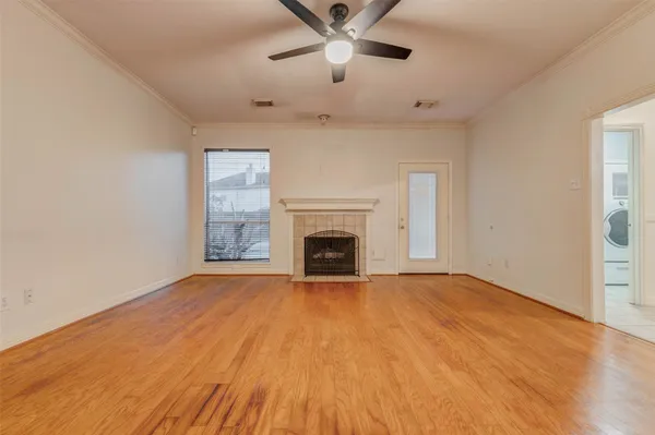 a view of an empty room with a fireplace and a window