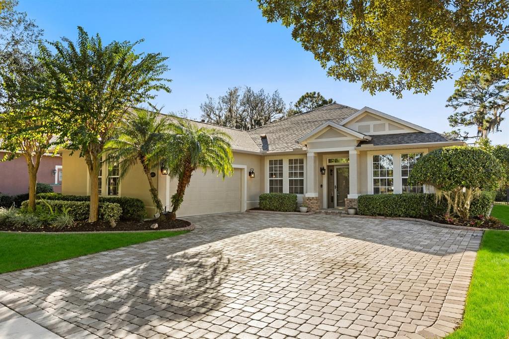 504 Garden Club Drive Deland, FL 32724 - Photo 1 of 35 a front view of a house with a garden and trees