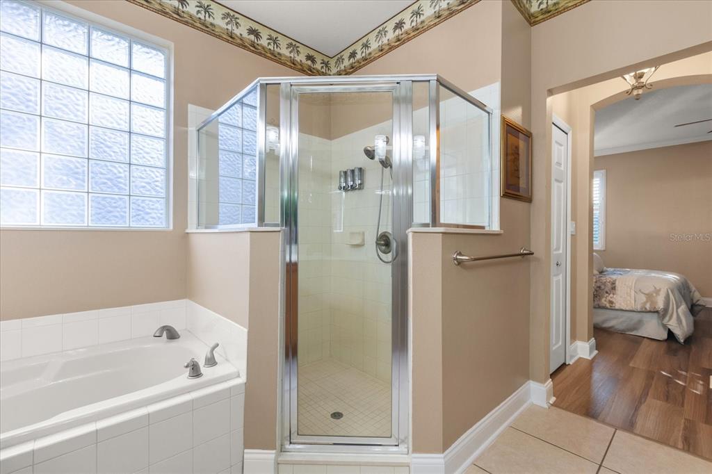 504 Garden Club Drive Deland, FL 32724 - Photo 18 of 35 a bathroom with a bathtub and a shower