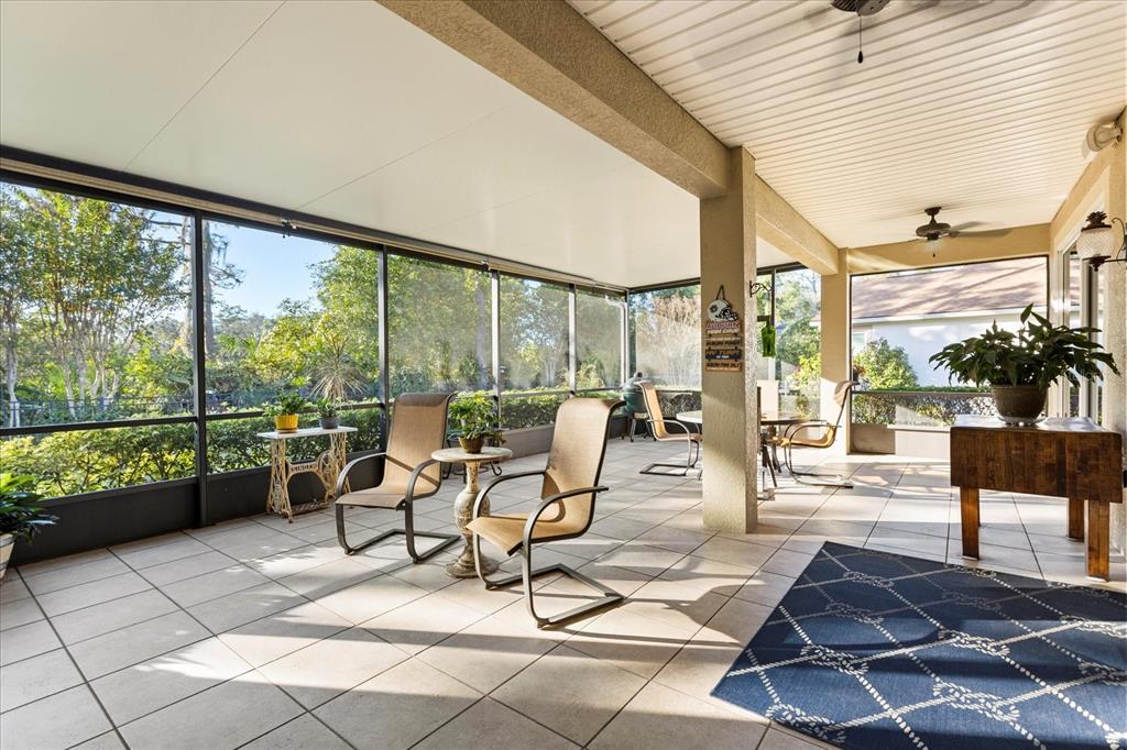 504 Garden Club Drive Deland, FL 32724 - Photo 25 of 35 a living room with furniture and a floor to ceiling window