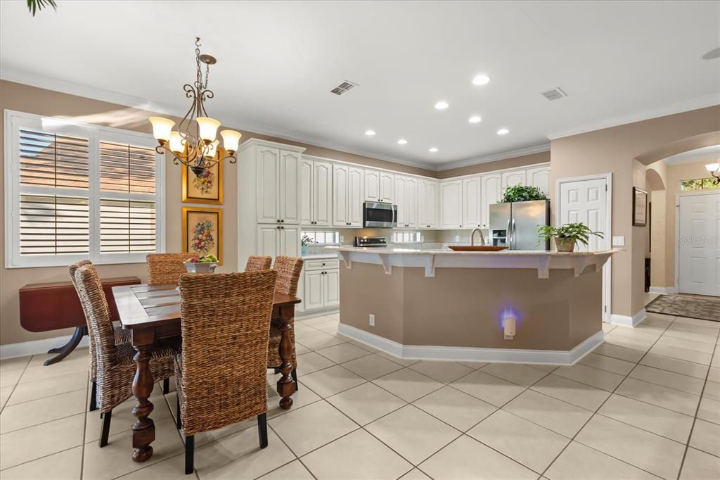 504 Garden Club Drive Deland, FL 32724 - Photo 5 of 35 a dining table chairs and a refrigerator