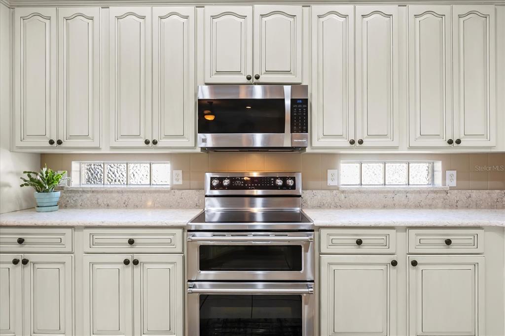 504 Garden Club Drive Deland, FL 32724 - Photo 7 of 35 a kitchen with granite countertop white cabinets and stainless steel appliances