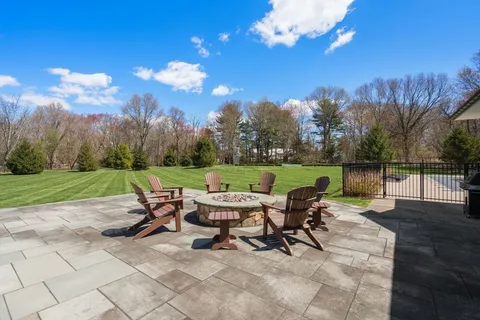 a view of a chairs and table in patio with a lake view