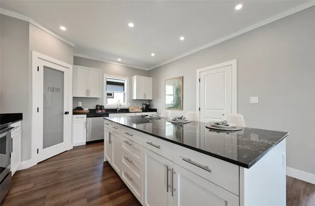 a kitchen with lot of counter space and wooden floor