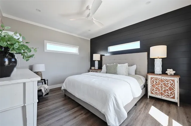 a bedroom with bed and a potted plant