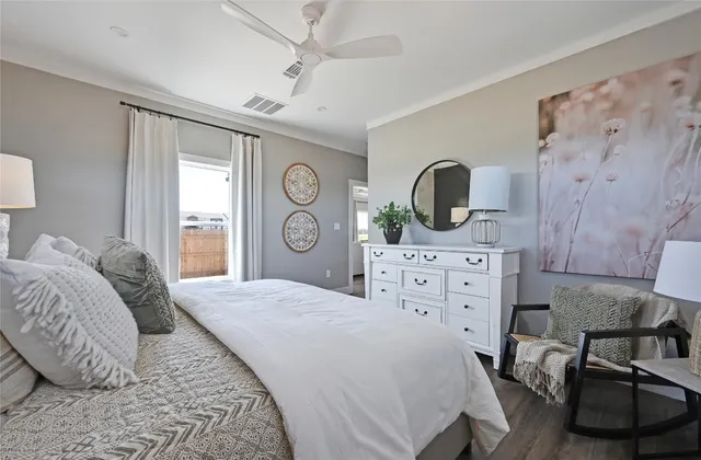 a bedroom with a bed couch and a window