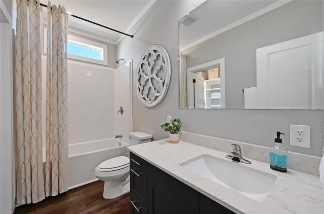 a bathroom with a toilet a sink and a mirror