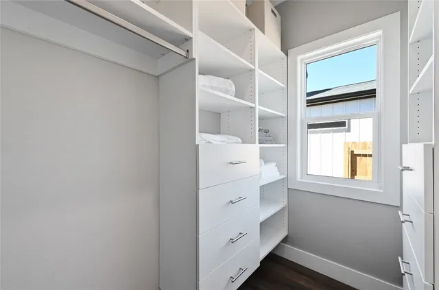 a room with a dresser and a window