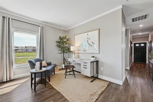a living room with furniture a wooden floor and a table
