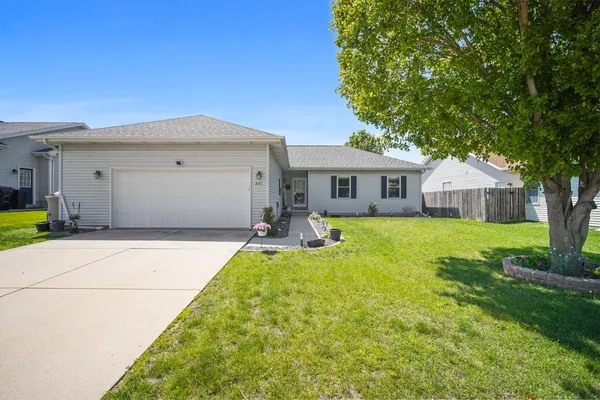 a front view of house with yard and green space