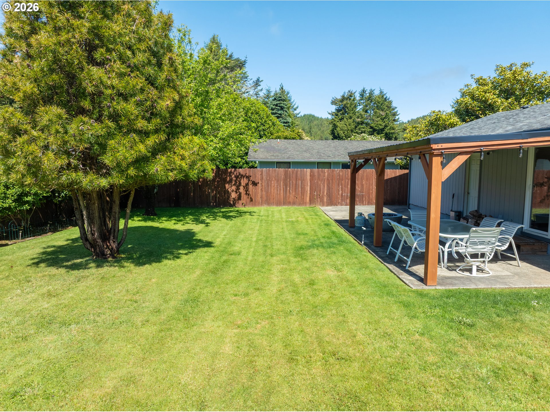 412 Camellia Court Reedsport, OR 97467 - Photo 43 of 48 a view of backyard with a barn and large trees