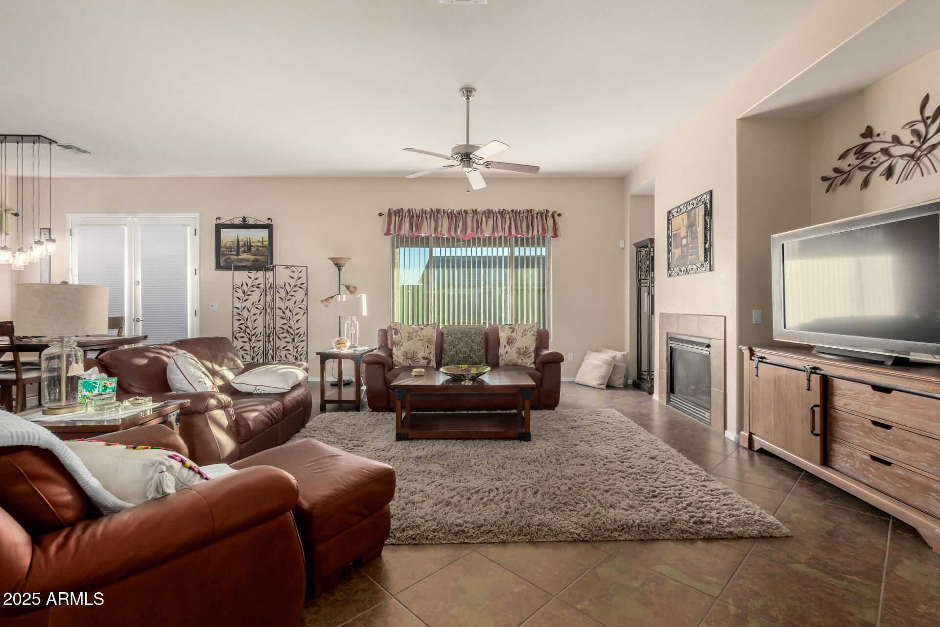 18115 West Desert View Lane Goodyear, AZ 85338 - Photo 11 of 57 a living room with furniture and a flat screen tv