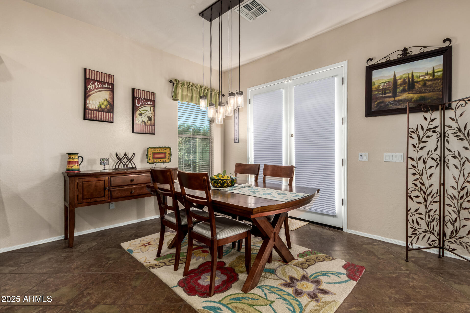 18115 West Desert View Lane Goodyear, AZ 85338 - Photo 17 of 57 a view of a dining room with furniture and chandelier