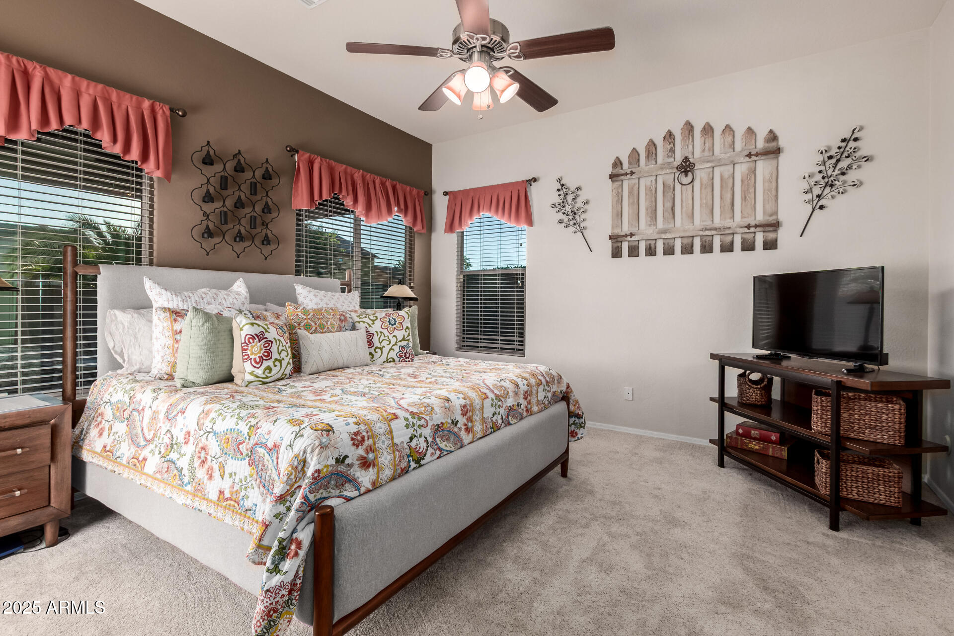 18115 West Desert View Lane Goodyear, AZ 85338 - Photo 19 of 57 a spacious bedroom with a bed and a flat screen tv