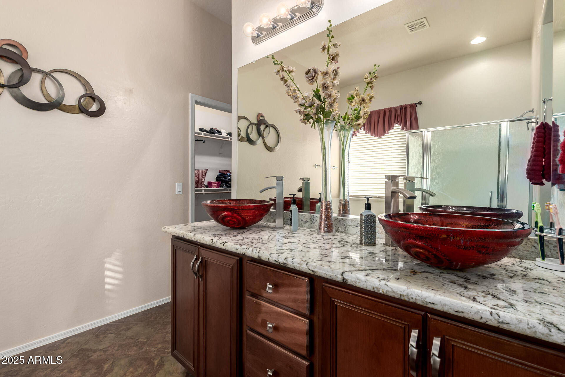 18115 West Desert View Lane Goodyear, AZ 85338 - Photo 21 of 57 a bathroom with a granite countertop sink and a mirror