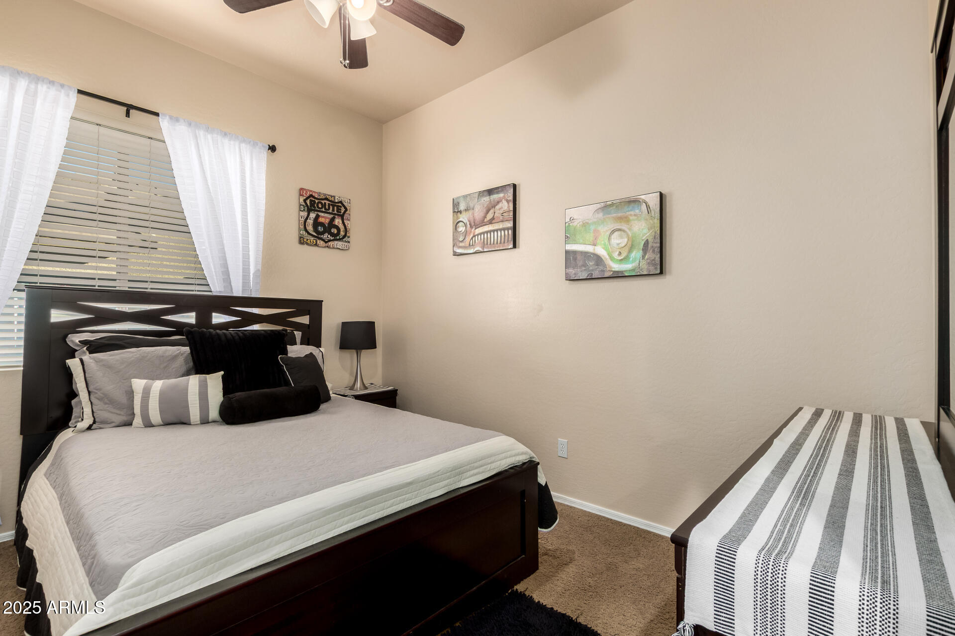 18115 West Desert View Lane Goodyear, AZ 85338 - Photo 23 of 57 a bedroom with a bed and a chandelier