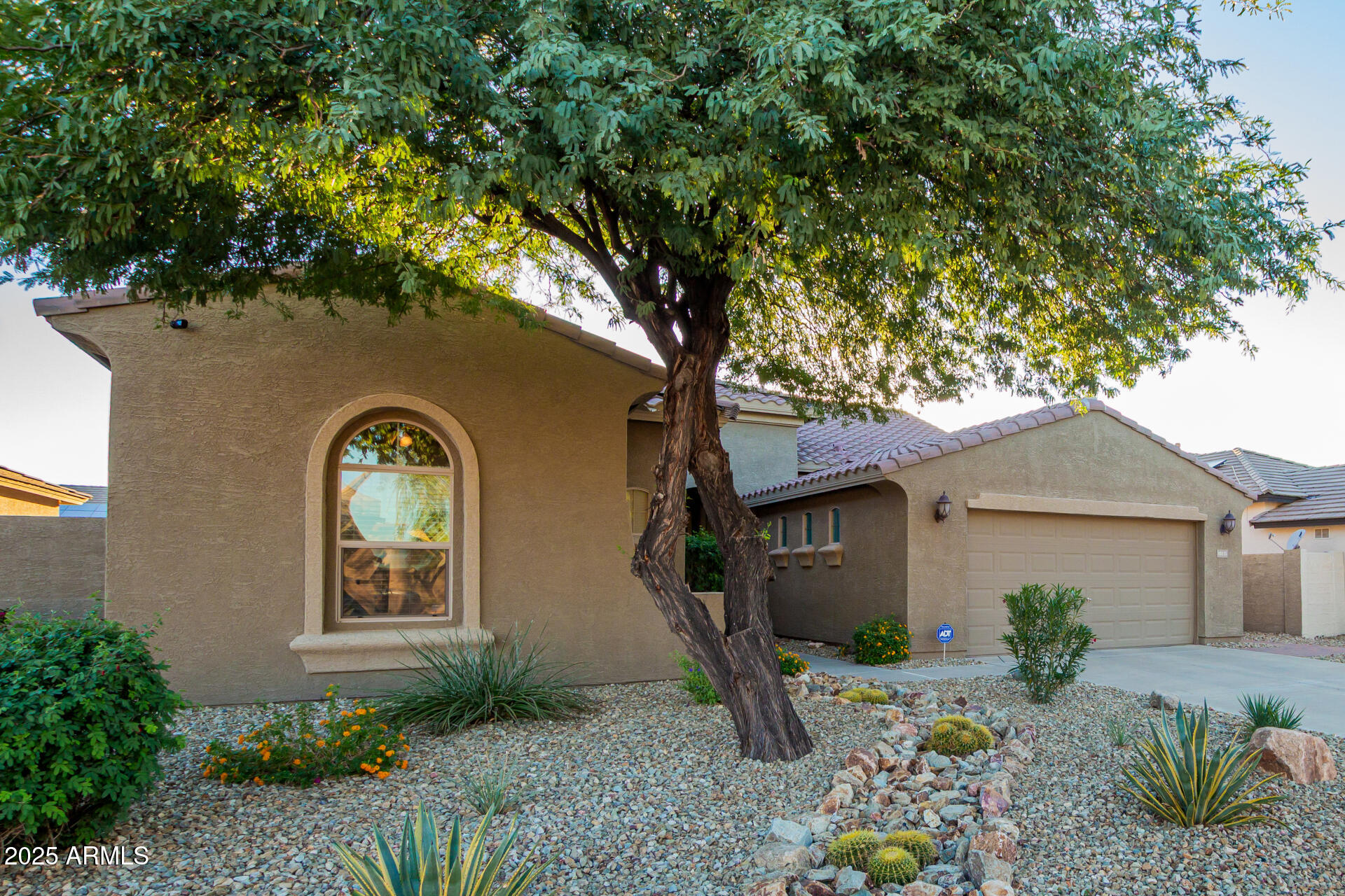 18115 West Desert View Lane Goodyear, AZ 85338 - Photo 3 of 57 a front view of a house with garden