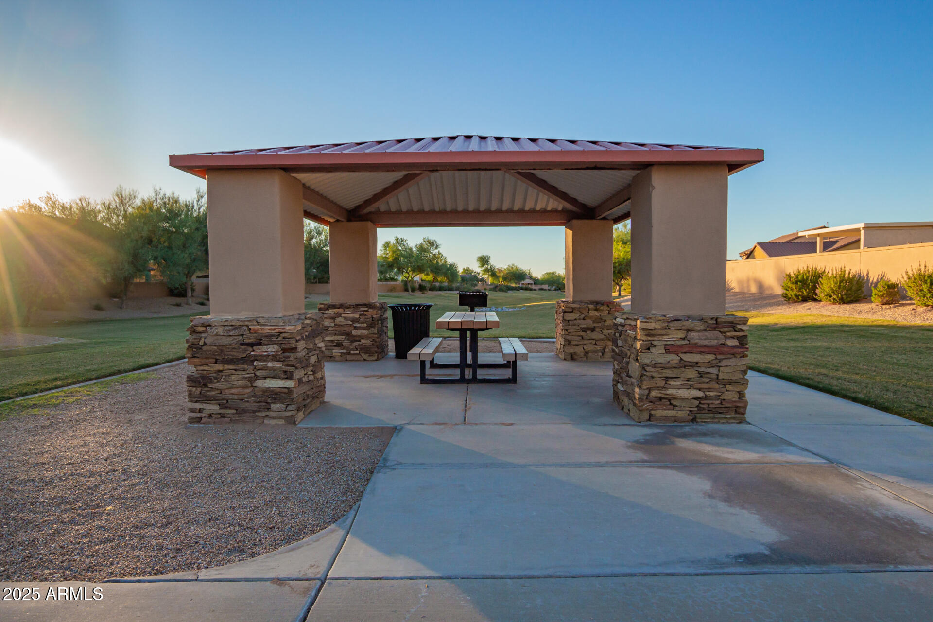 18115 West Desert View Lane Goodyear, AZ 85338 - Photo 37 of 57 a view of patio with table and chairs under an umbrella