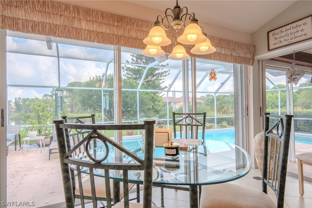 7181 Appleby Drive Naples, FL 34104 - Photo 11 of 29 a view of a dining room with furniture wooden floor and a chandelier