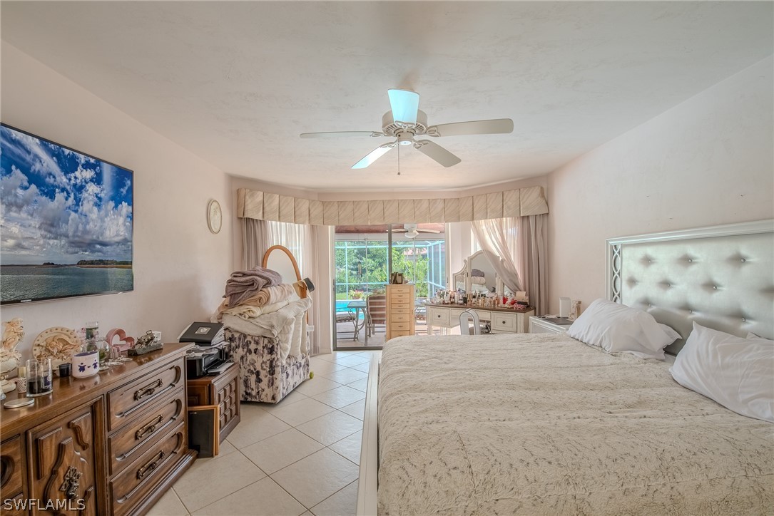 7181 Appleby Drive Naples, FL 34104 - Photo 15 of 29 a large bedroom with a bed and a large window