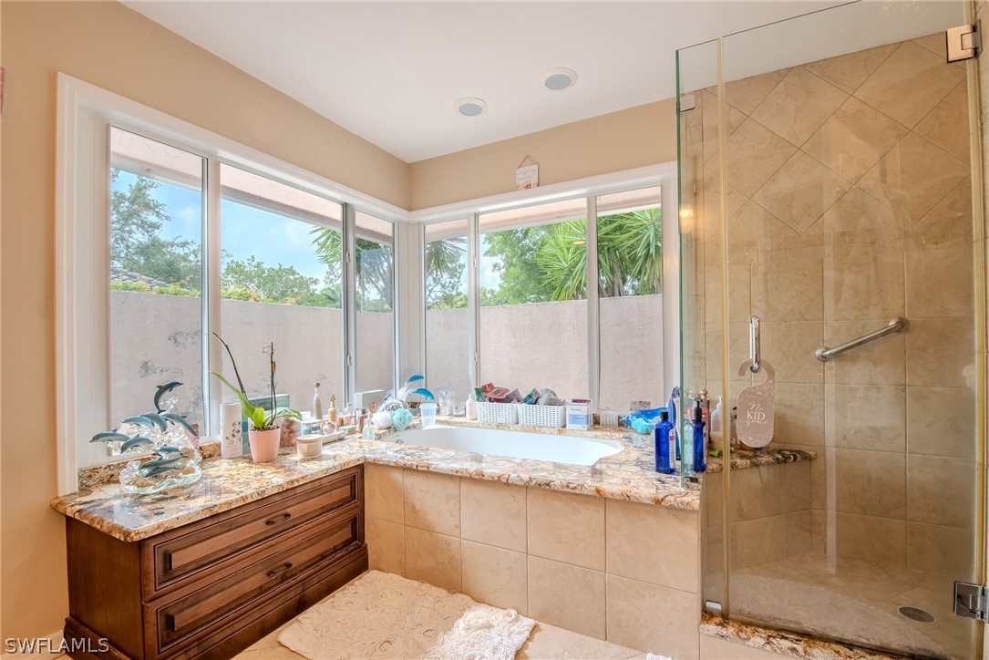 7181 Appleby Drive Naples, FL 34104 - Photo 17 of 29 a bathroom with a granite countertop sink mirror and a shower
