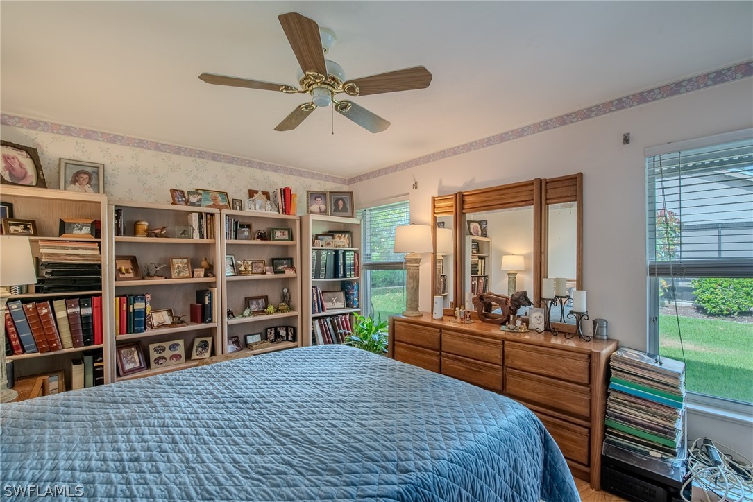 7181 Appleby Drive Naples, FL 34104 - Photo 20 of 29 a bedroom with furniture and a book shelf