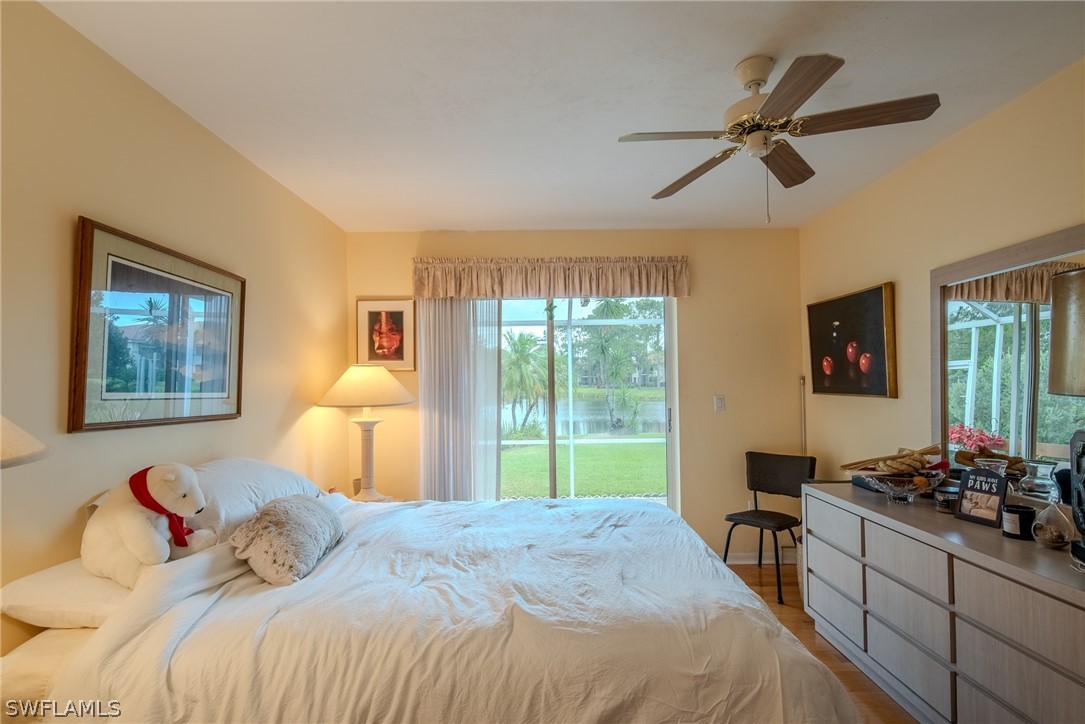 7181 Appleby Drive Naples, FL 34104 - Photo 24 of 29 a bedroom with a bed and a large window