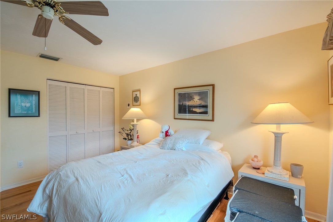 7181 Appleby Drive Naples, FL 34104 - Photo 25 of 29 a bedroom with a bed and a lamp