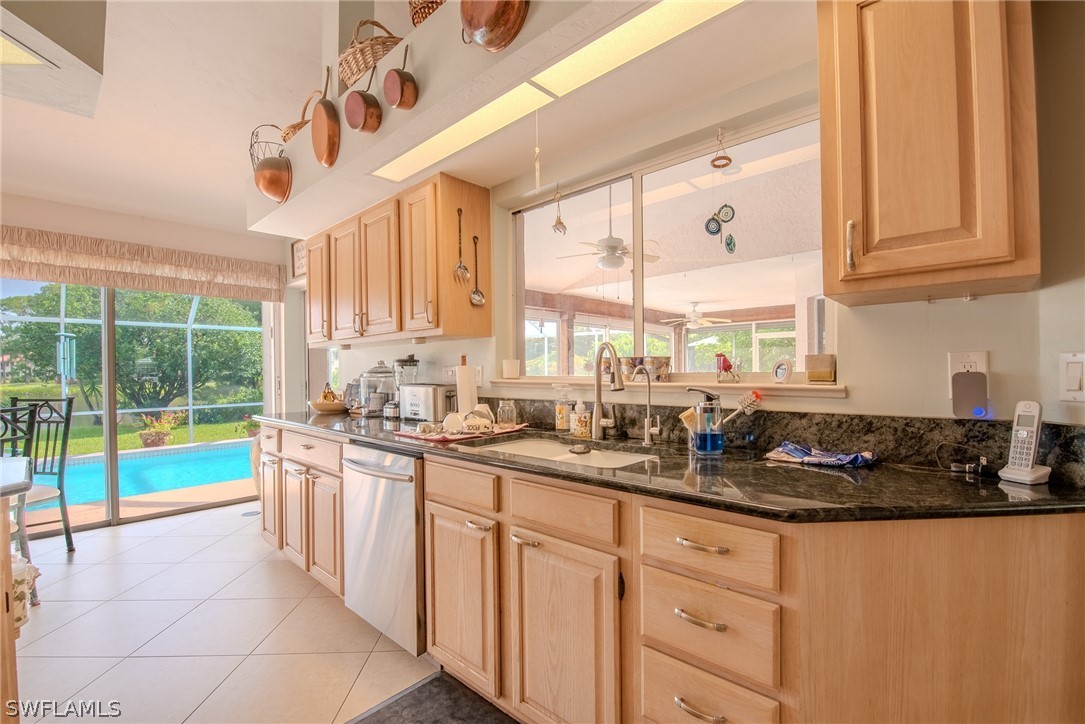 7181 Appleby Drive Naples, FL 34104 - Photo 3 of 29 a kitchen with stainless steel appliances granite countertop a sink a stove and cabinets