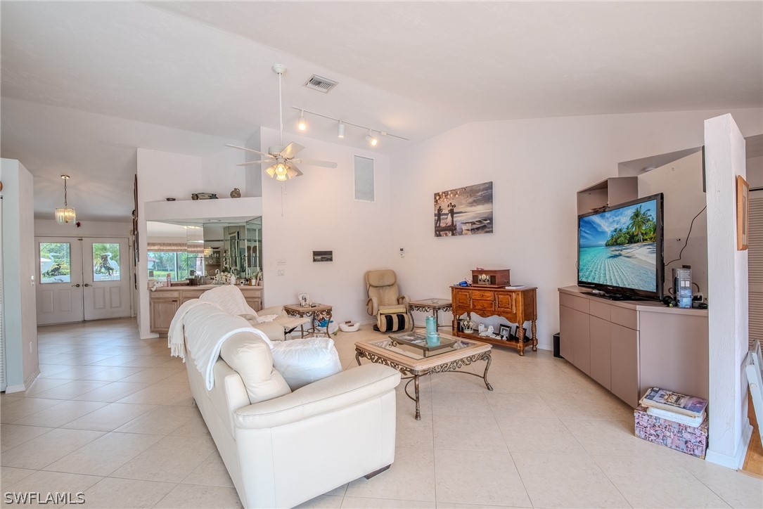 7181 Appleby Drive Naples, FL 34104 - Photo 7 of 29 a living room with furniture and a flat screen tv