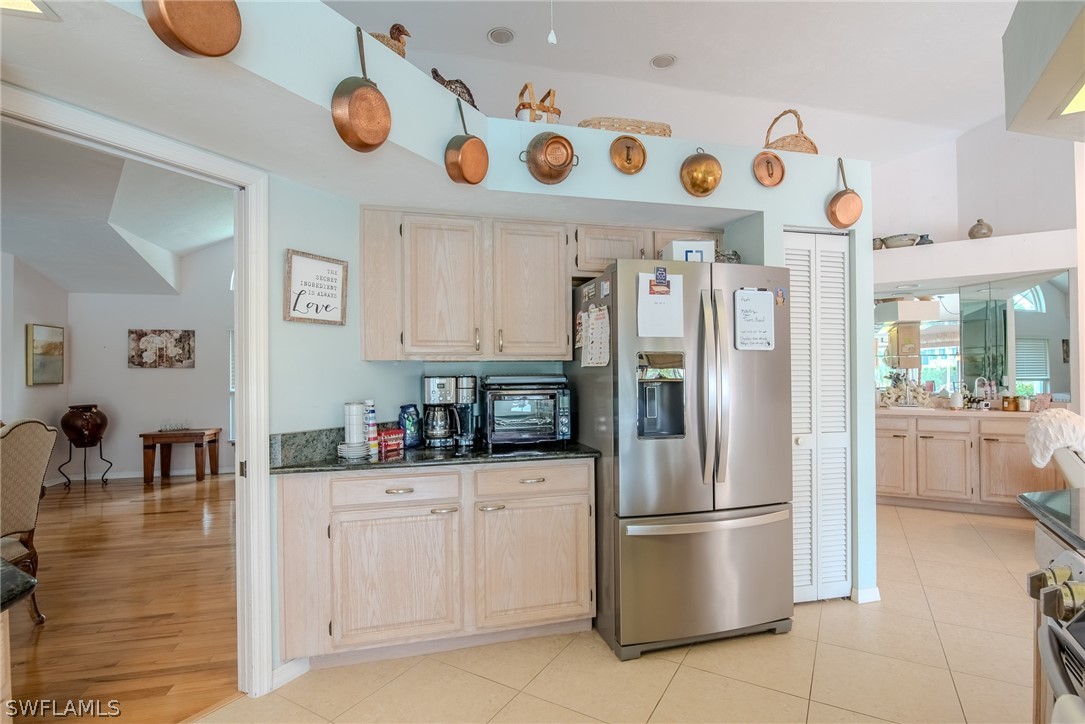7181 Appleby Drive Naples, FL 34104 - Photo 10 of 29 a kitchen with stainless steel appliances and cabinets
