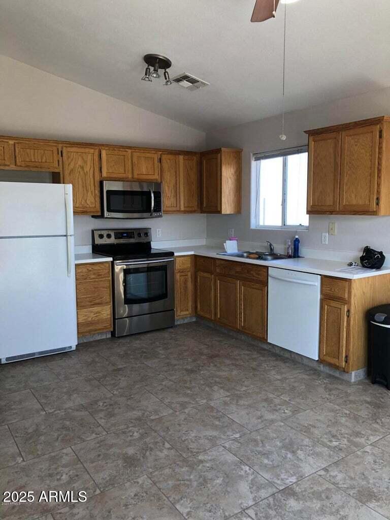 14283 South Tampico Road Arizona City, AZ 85123 - Photo 2 of 3 a kitchen with stainless steel appliances granite countertop a sink a stove top oven a counter space and cabinets