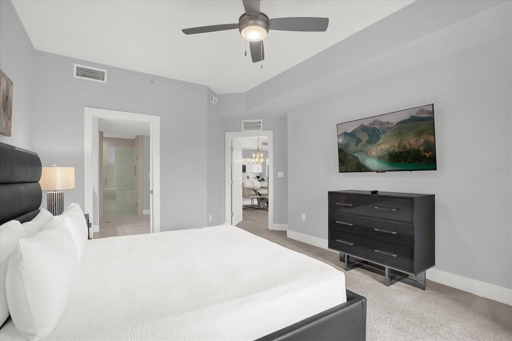 8774 Worldquest Boulevard Orlando, FL 32821 - Photo 15 of 35 a bedroom with a bed and a flat screen tv