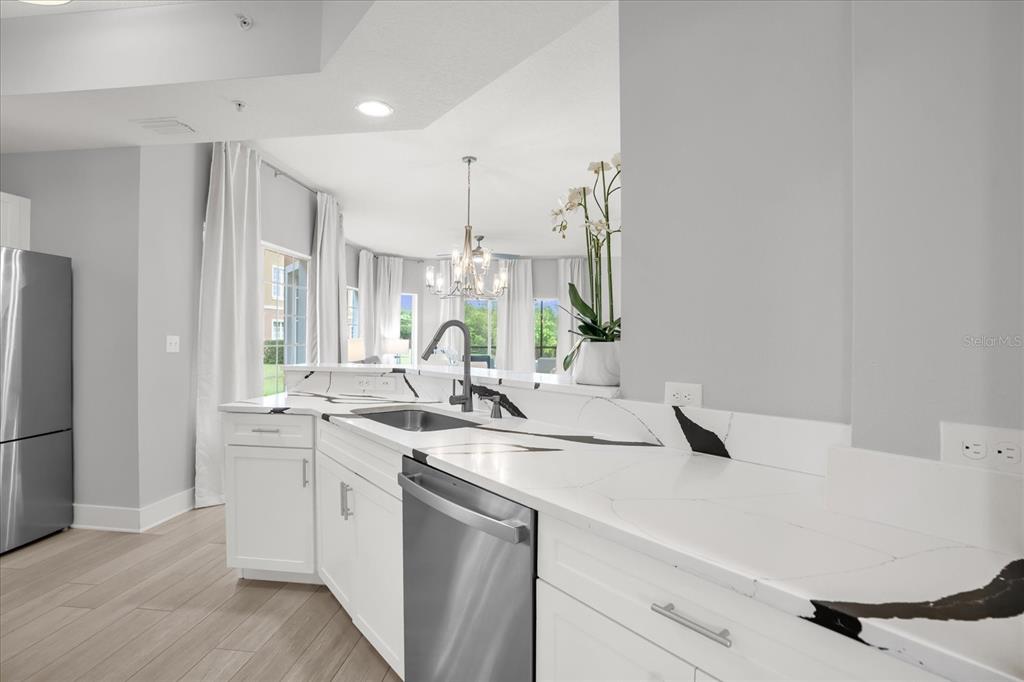 8774 Worldquest Boulevard Orlando, FL 32821 - Photo 18 of 35 a kitchen with a sink appliances and cabinets