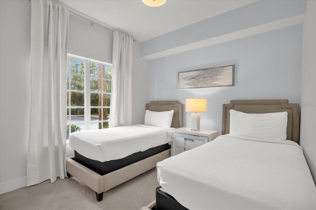 8774 Worldquest Boulevard Orlando, FL 32821 - Photo 20 of 35 a bedroom with two beds and a window