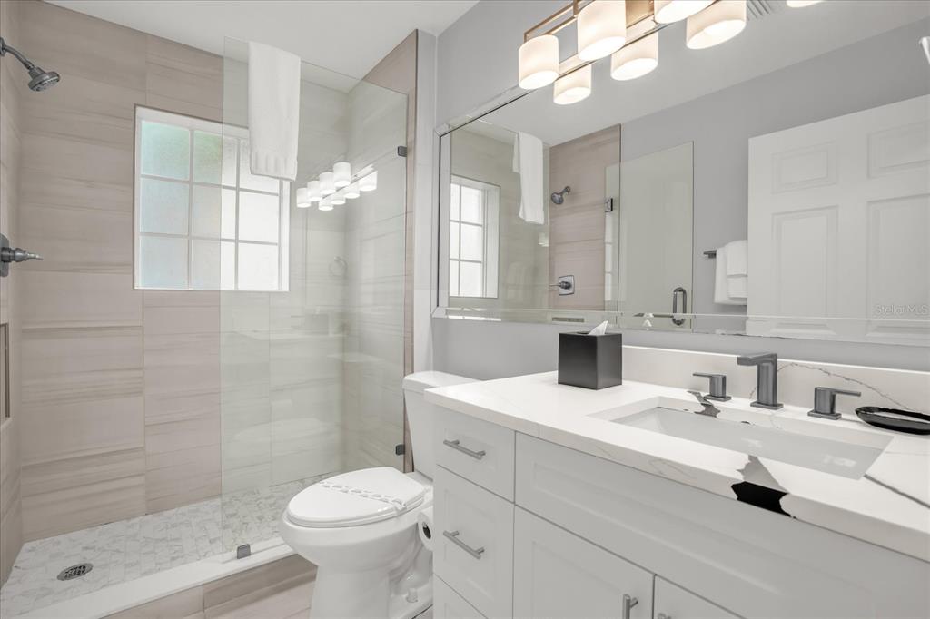 8774 Worldquest Boulevard Orlando, FL 32821 - Photo 21 of 35 a bathroom with a sink a toilet and shower