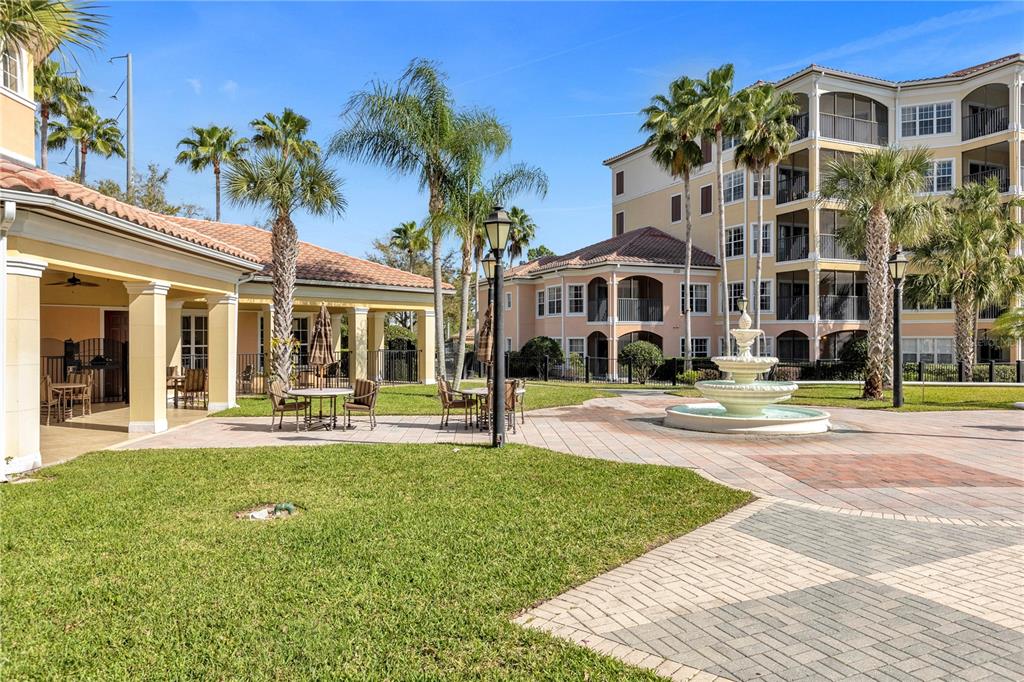 8774 Worldquest Boulevard Orlando, FL 32821 - Photo 32 of 35 a front view of a house with swimming pool and porch with furniture