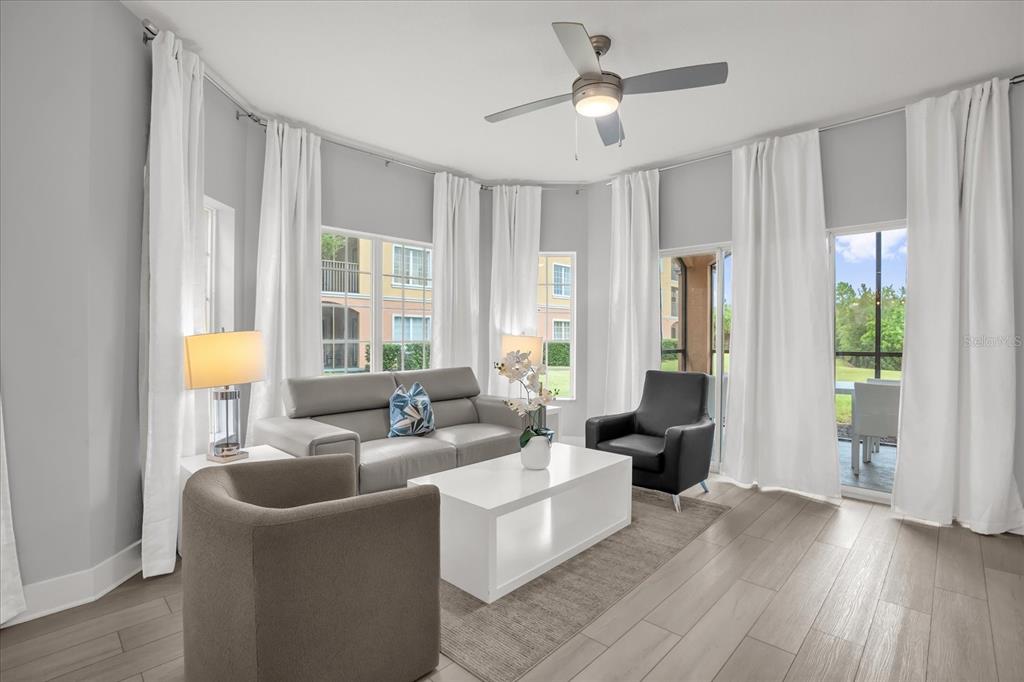 8774 Worldquest Boulevard Orlando, FL 32821 - Photo 7 of 35 a living room with furniture and a large window