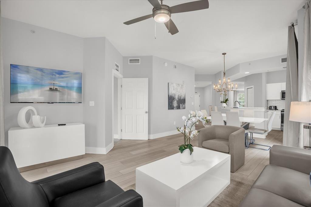 8774 Worldquest Boulevard Orlando, FL 32821 - Photo 8 of 35 a living room with furniture and a chandelier